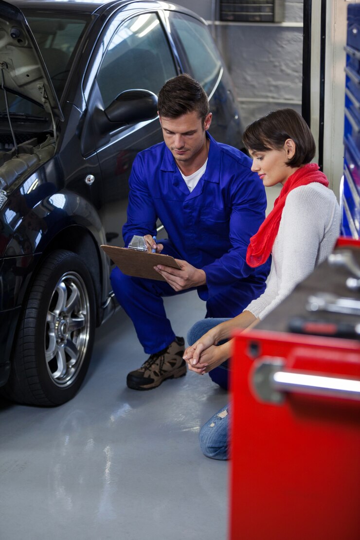 Mechanic showing quotation to customer at Insta Auto Parts